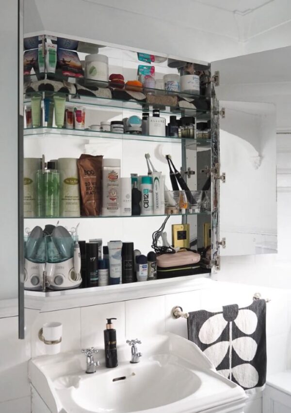 the IKEA Godmorgon bathroom cabinet with lots of toiletries and beauty products stored inside