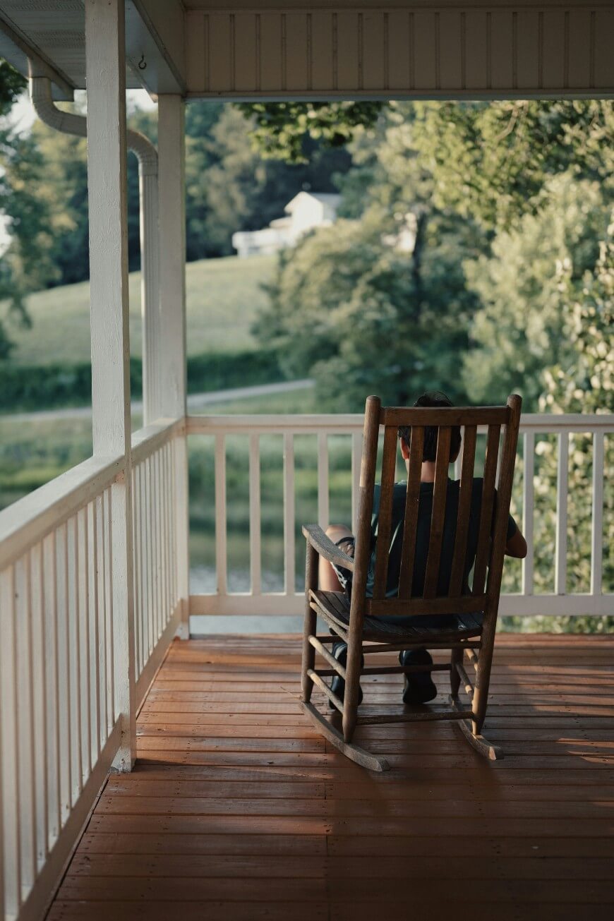 boy sitting on chair on deck