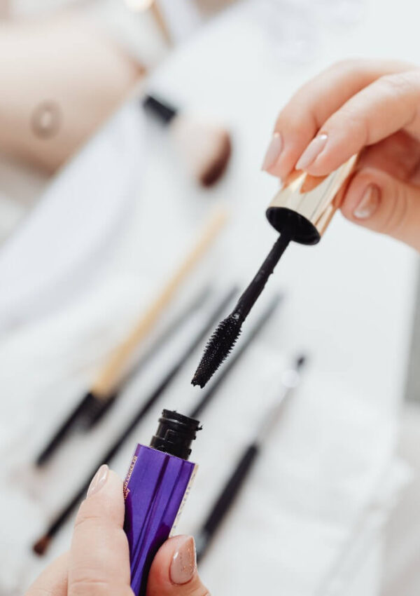 woman holding dry mascara