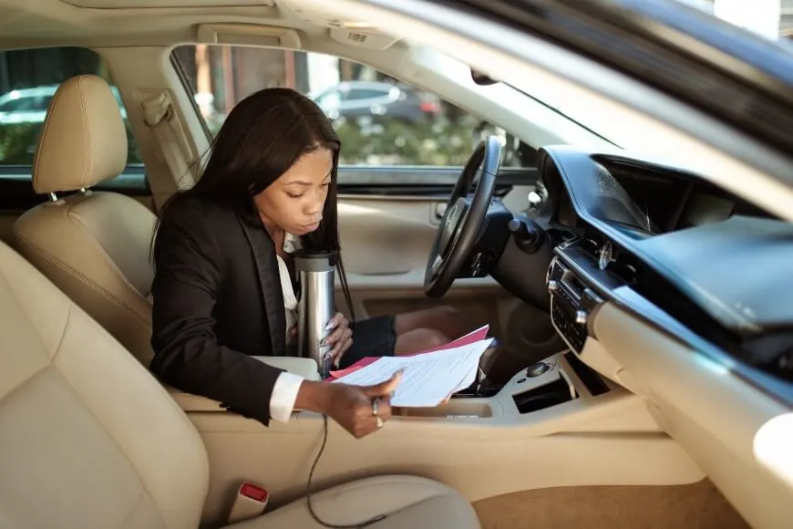 woman reading documents in a car