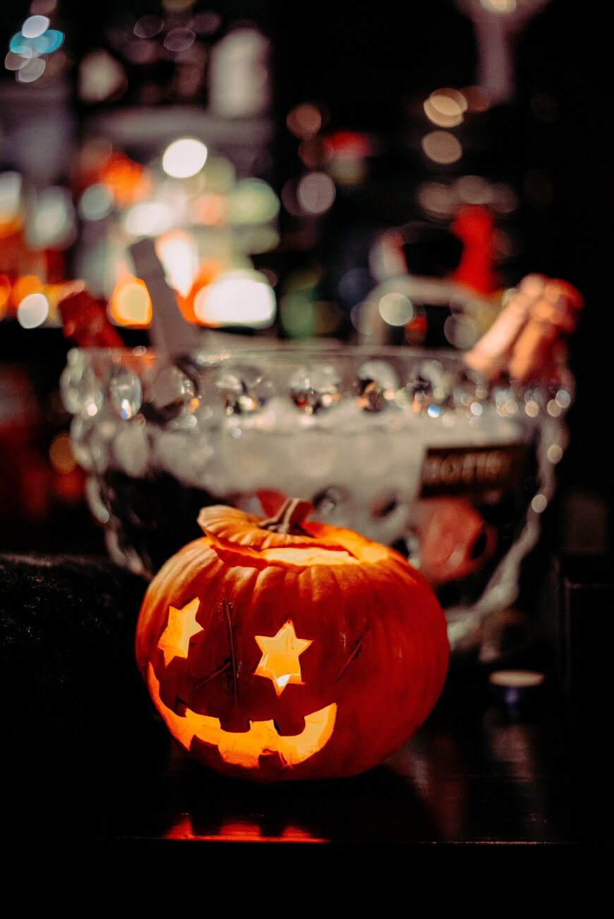 halloween cocktails in ice bucket with carved pumpkin
