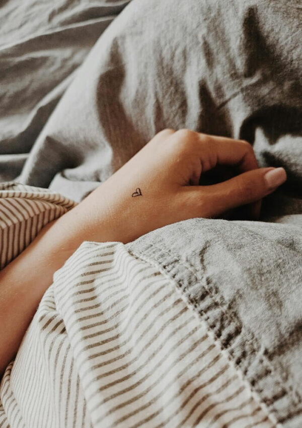 small heart tattoo on hand