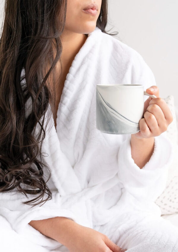 woman in robe drinking morning coffee