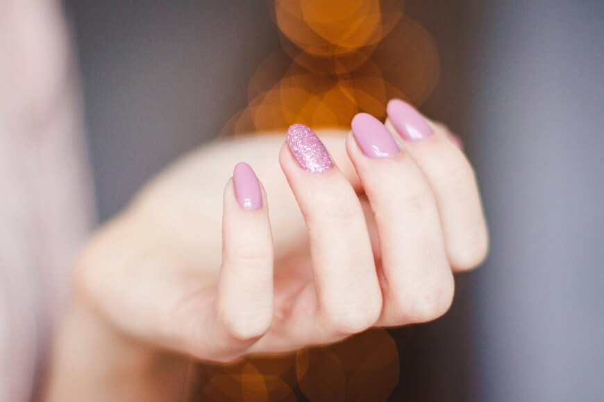 pink nail with glitter accent