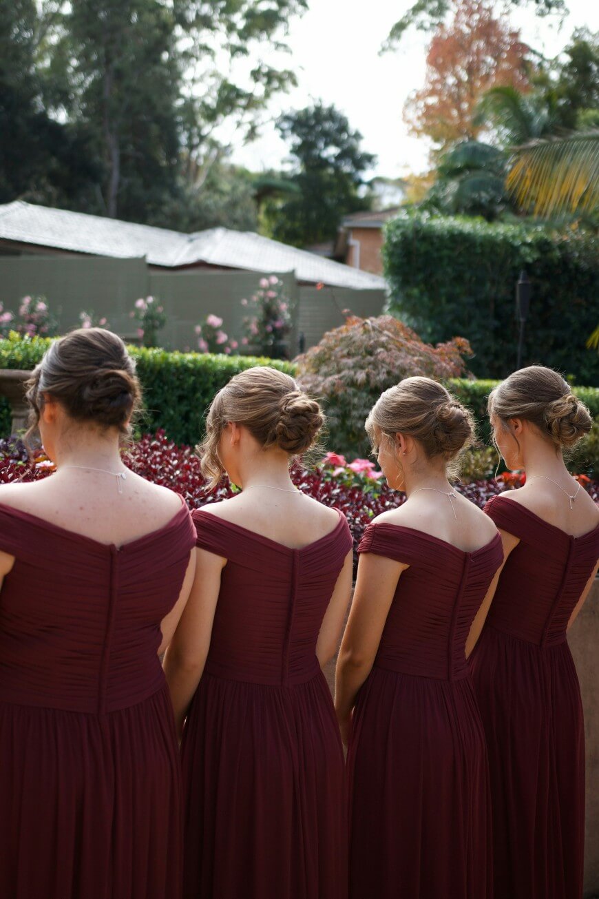 row of bridesmaids with updo hairstyles