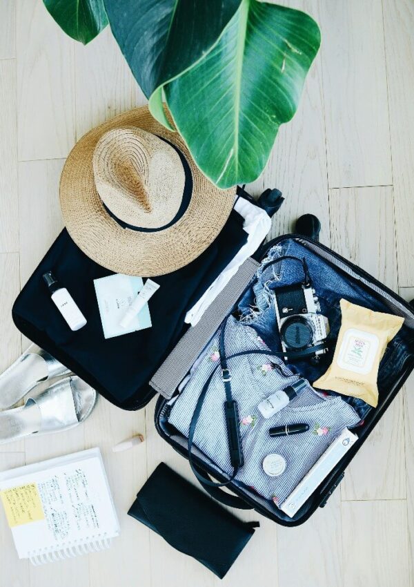 suitcase with beach packing essentials