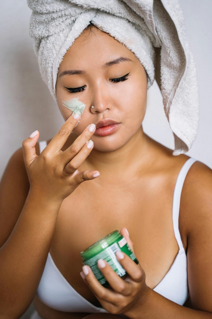 woman applying moisturizer