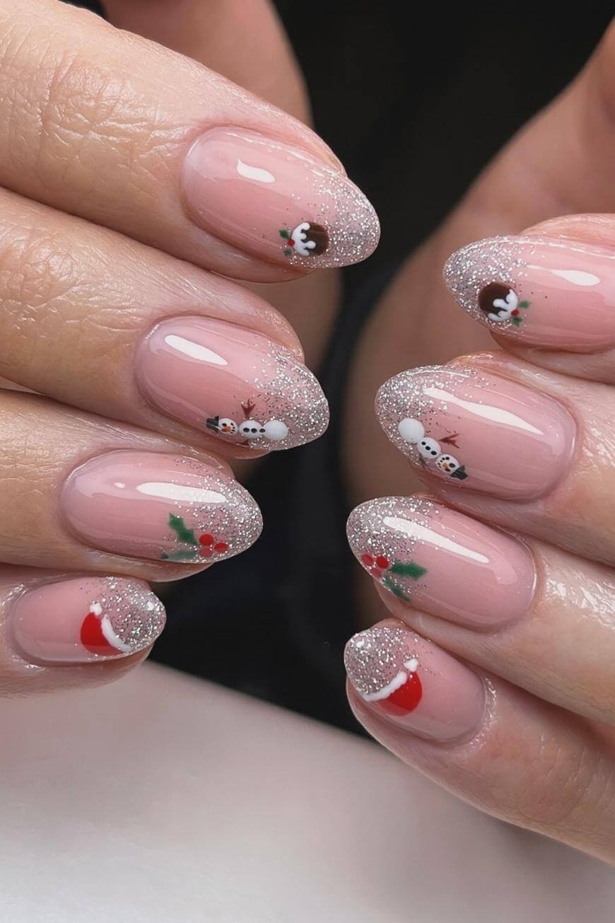 A set of manicured nails with a light pink base, silver glitter tips, and festive designs including snowmen, holly, and red stockings, creating a holiday-themed look.