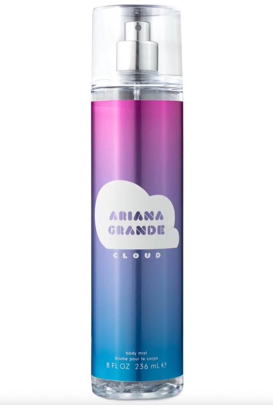 A tall bottle of Ariana Grande Cloud body mist with a gradient design in purple, pink, and blue, featuring a white cloud logo and silver spray top. The bottle holds 8 fl oz (236 mL).