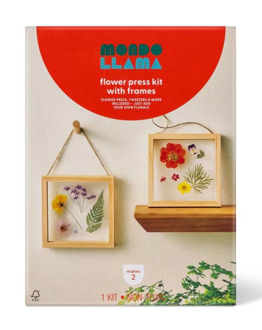 Box of Mondo Llama flower press kit with frames. The package shows two square wooden frames with pressed, colorful flowers and greenery, one hanging on a wall and one resting on a surface. Text highlights kit contents.