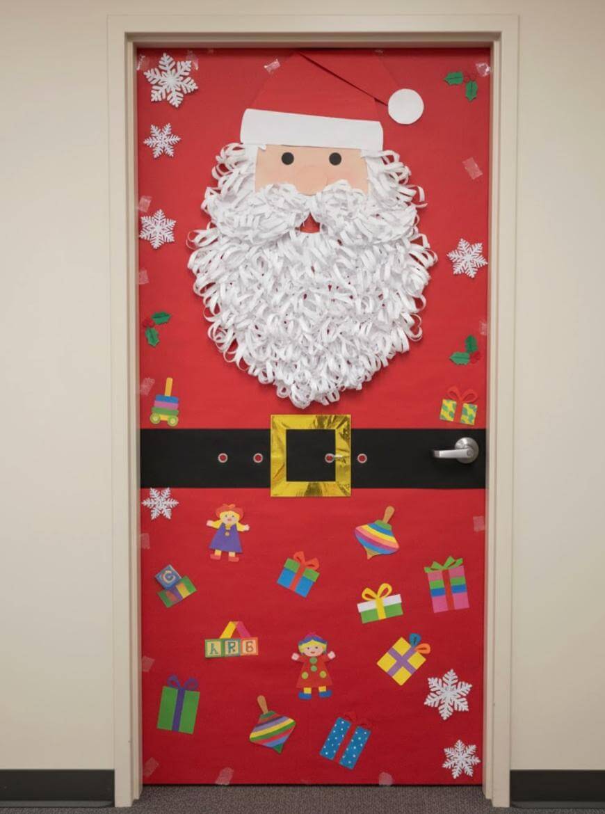 A door decorated as Santa Claus with a large paper beard, hat, and belt on a red background. The door is adorned with snowflakes, toys, and gift illustrations, creating a festive holiday theme.