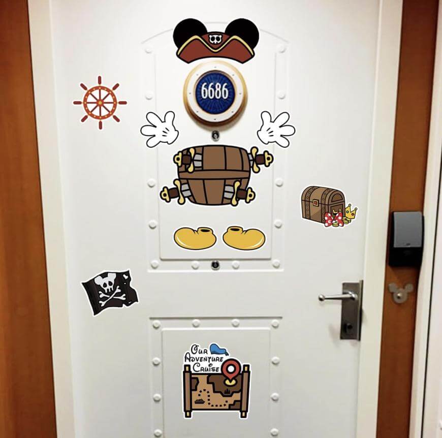 A white door decorated with Disney pirate and treasure-themed stickers, including Mickey Mouse gloves, shoes, a pirate hat, treasure chests, a pirate flag, and a map. The number 6686 is displayed in a round frame.