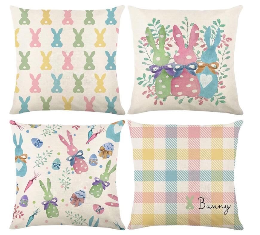Four decorative throw pillows with pastel Easter designs: bunny silhouettes, three bunnies with bows, bunnies with eggs and florals, and a pastel plaid pattern with the word Bunny in the bottom right corner.