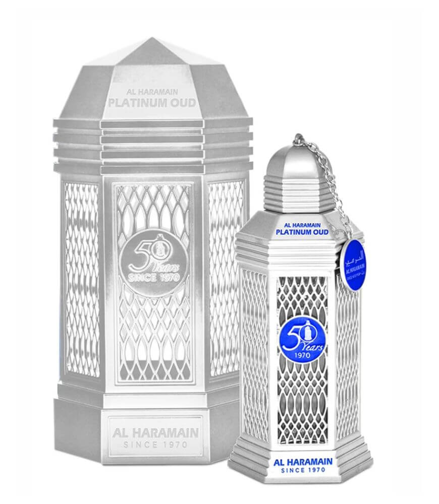 A silver, lantern-shaped perfume bottle and matching box, both labeled Al Haramain Platinum Oud and 50 Years Since 1970, with blue accents and a chain on the bottles cap.