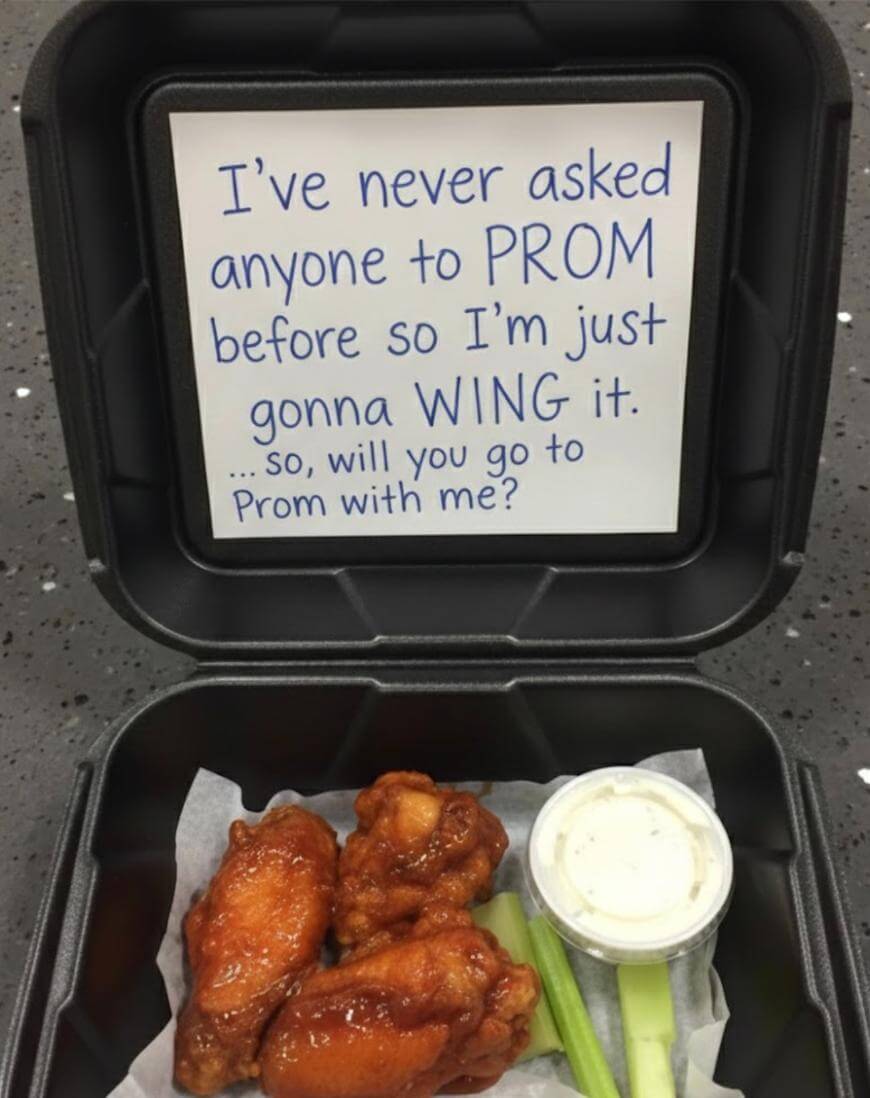 A takeout box with chicken wings, celery, and ranch dip. The inside lid has a note: Ive never asked anyone to PROM before so I’m just gonna WING it. ...so, will you go to Prom with me?.