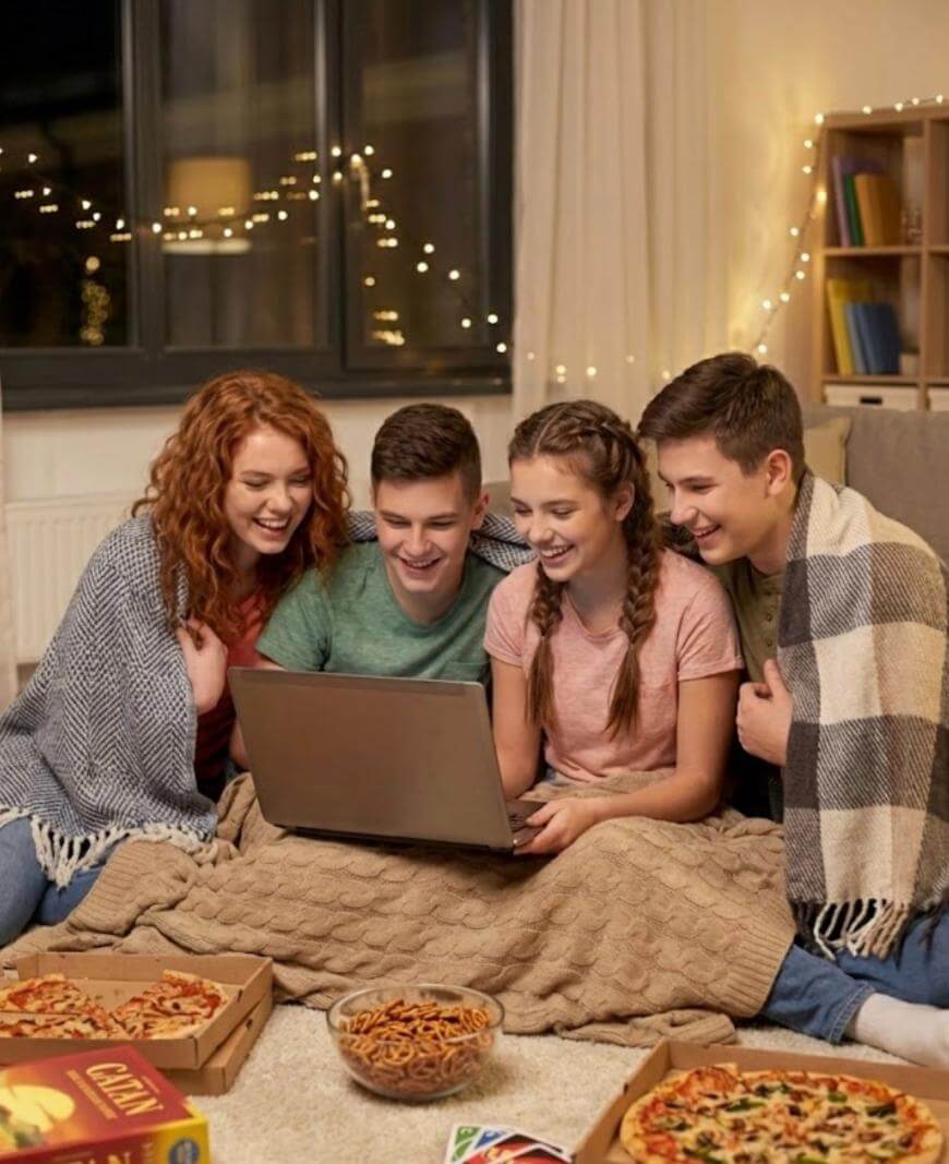 A group of people looking at a laptop.