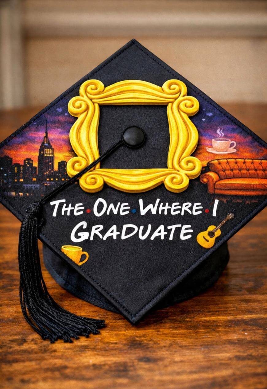 A graduation cap decorated with the yellow picture frame, sofa, and coffee cup motifs from the TV show Friends, with the words The One Where I Graduate written on it.