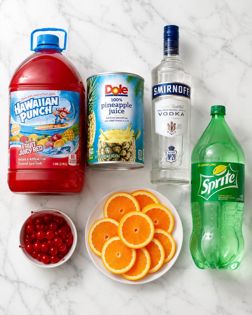 A bottle of Hawaiian Punch, a can of pineapple juice, a bottle of vodka, a bottle of Sprite, a bowl of cherries, and a plate of orange slices on a marble surface.