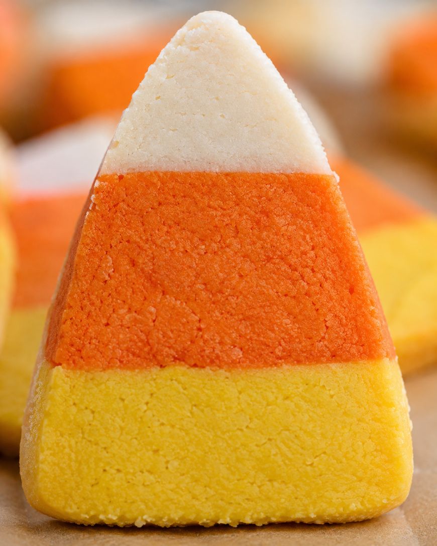 A close-up of a candy corn treat with three distinct layers