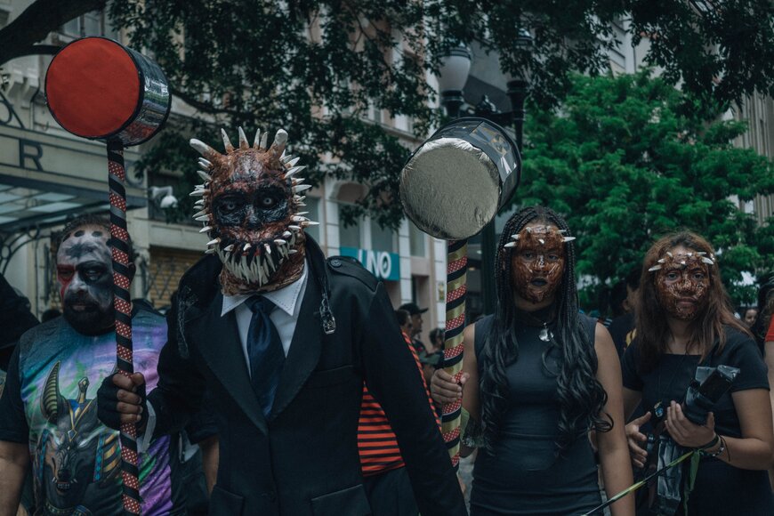 A group of four in elaborate monster masks for a dramatic Halloween group costume.