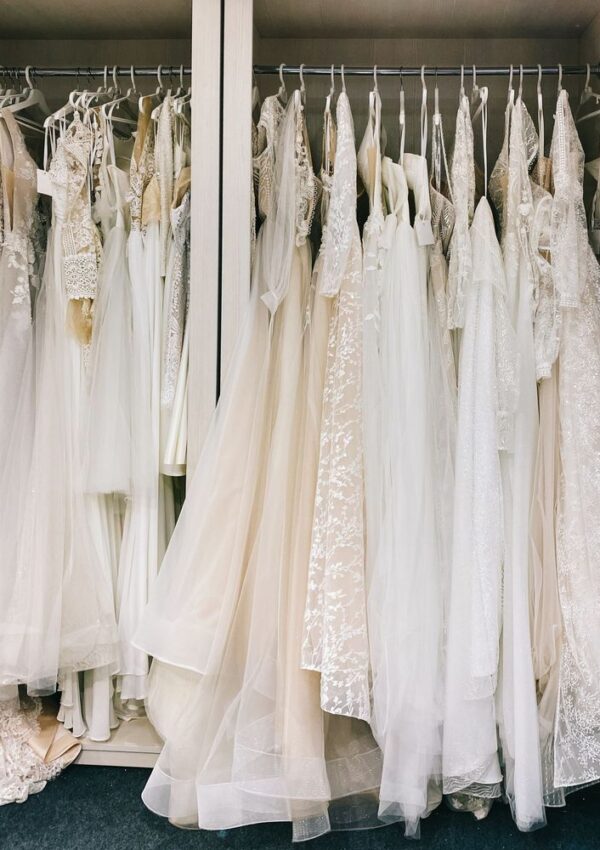 Wedding dresses hanging on a boutique rail