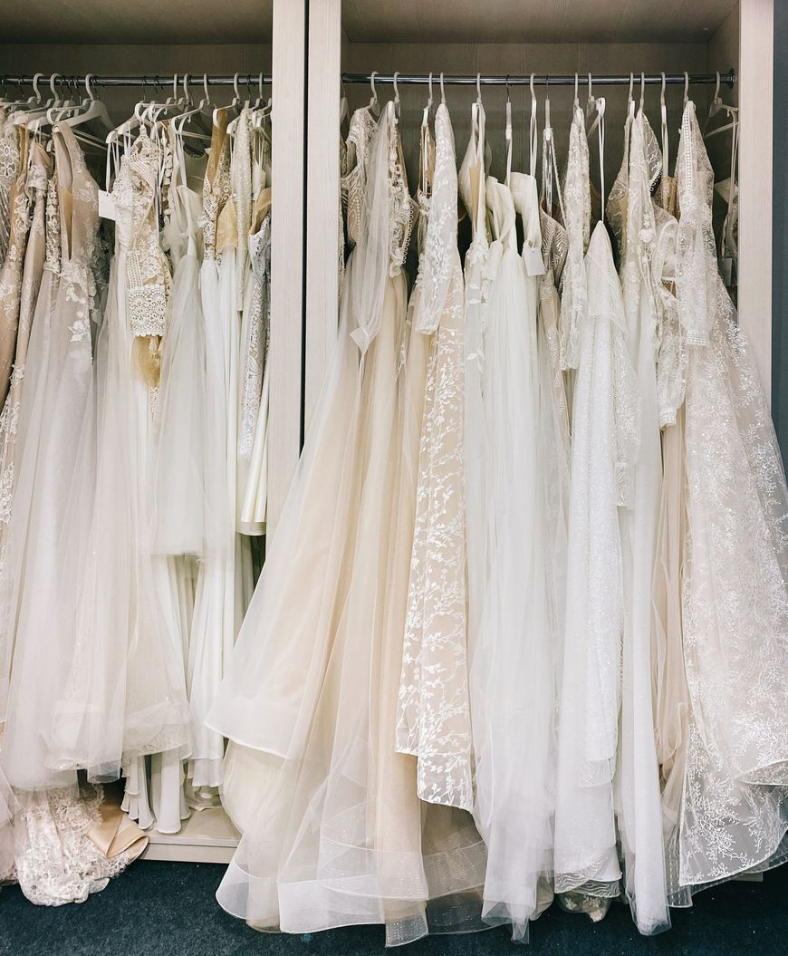 Wedding dresses hanging on a boutique rail